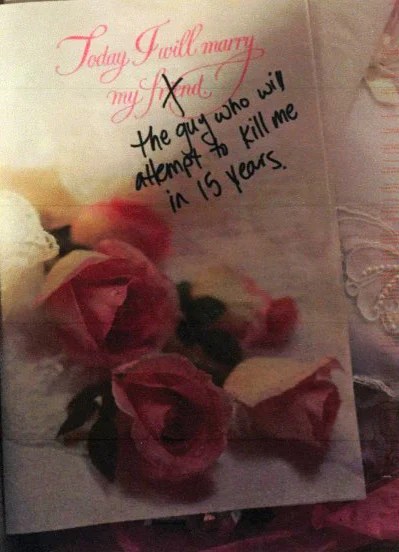A wedding card featuring pink roses and elegant text.