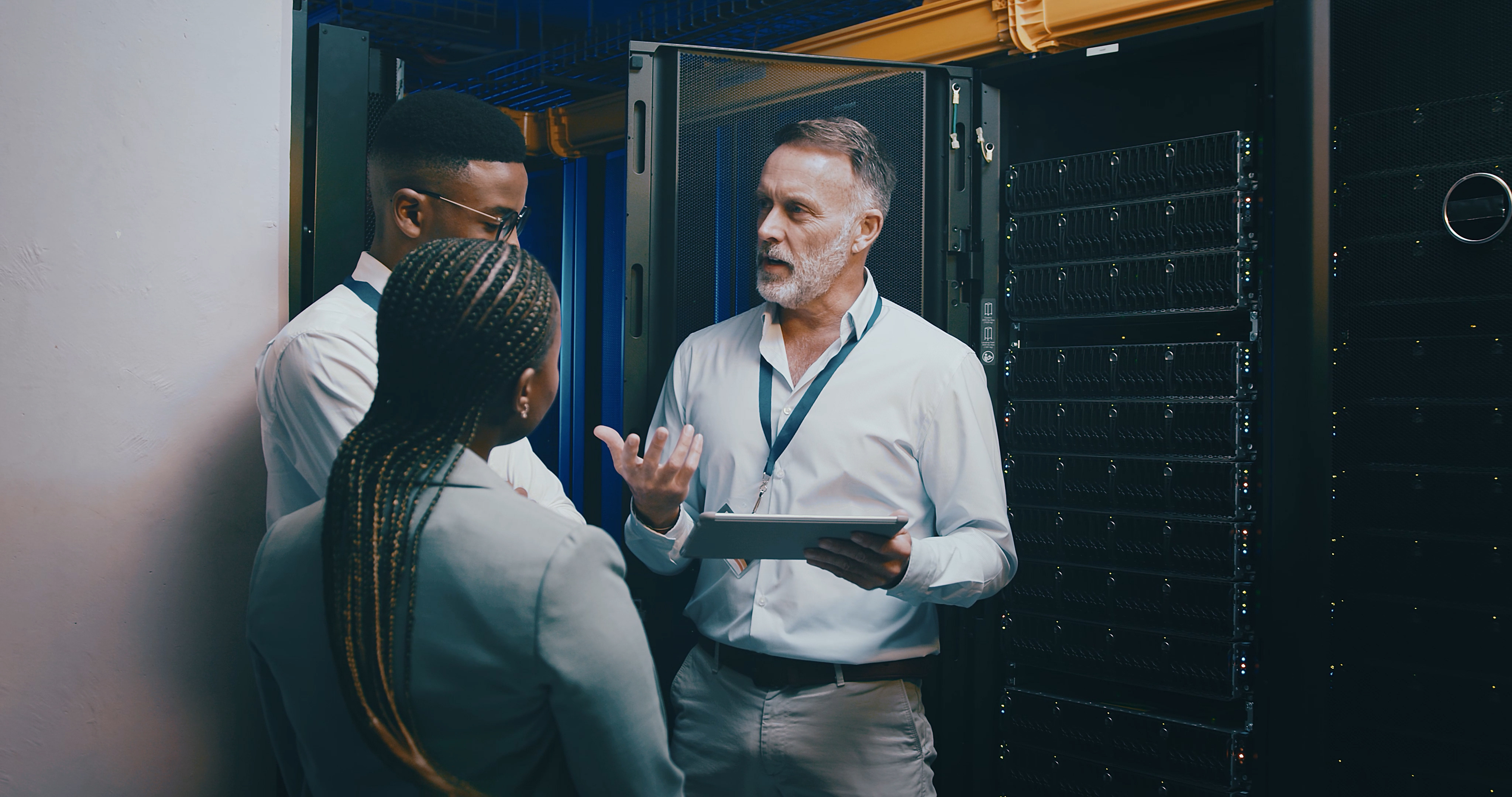 Server room, training and manager with people on tablet for cybersecurity, diagnostics test and maintenance. IT team, meeting and worker with boss for network, online database and technical support.