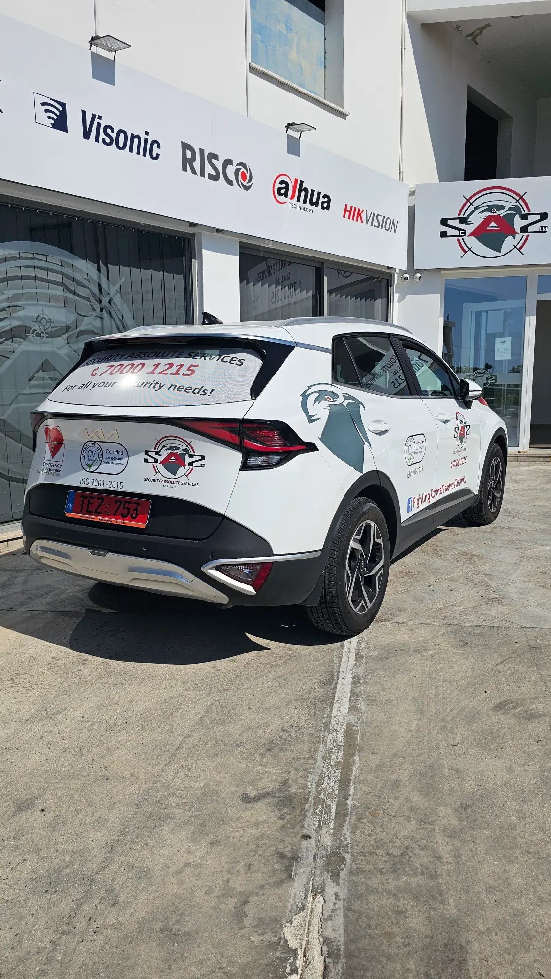 security patrol vehicle outside emba head office. Signs mention visonic, risco, dahau and hikvision
