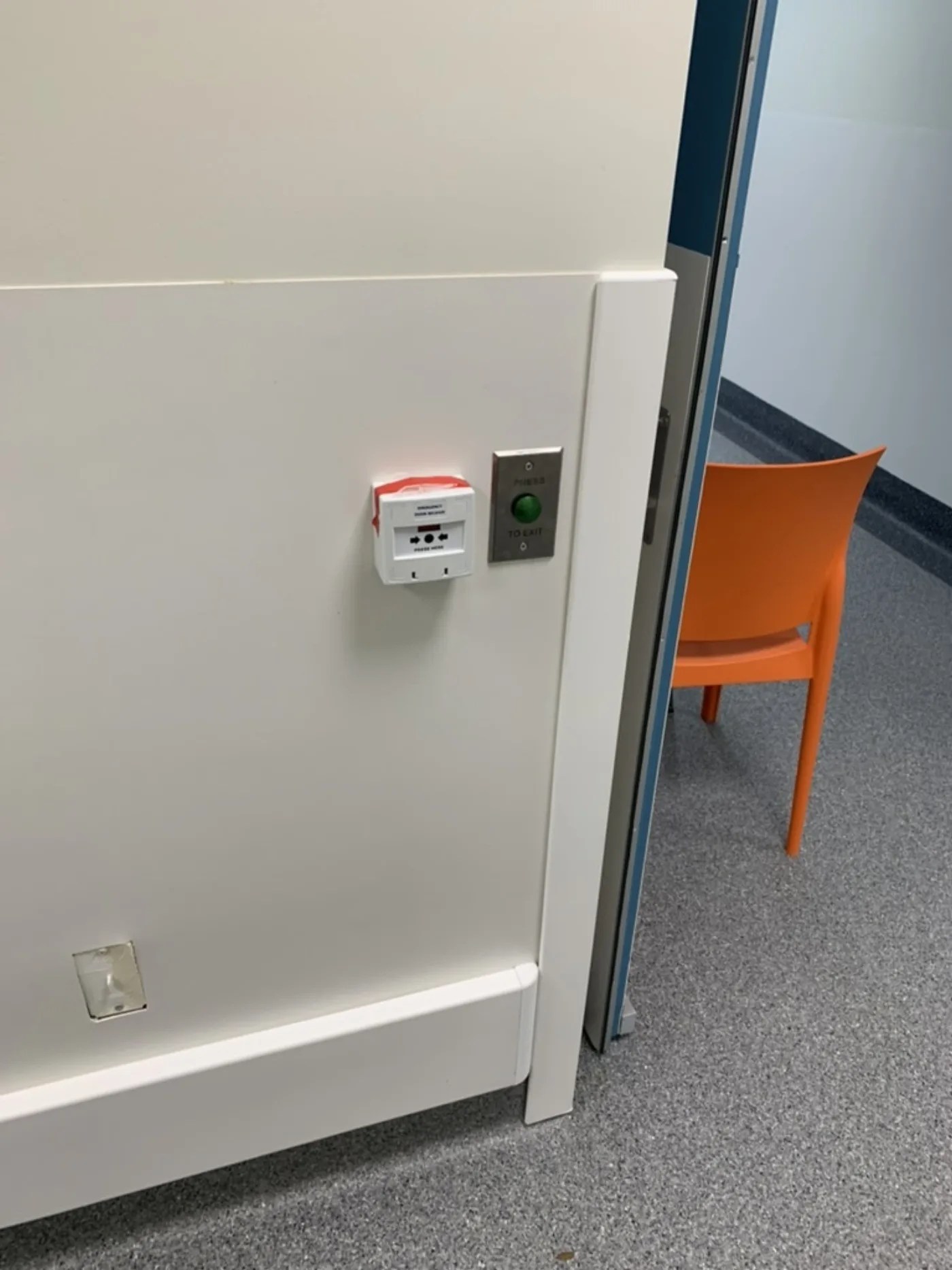 Green request-to-exit button and emergency door release beside a controlled door, installed by Security Response Sydney