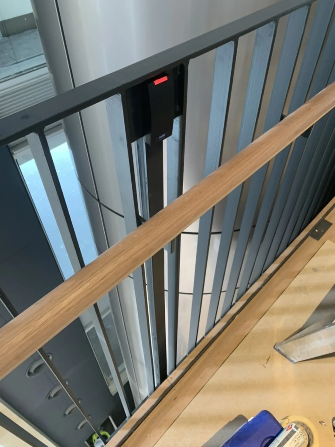Access control reader mounted on a stair-landing gate, installed by Security Response Sydney