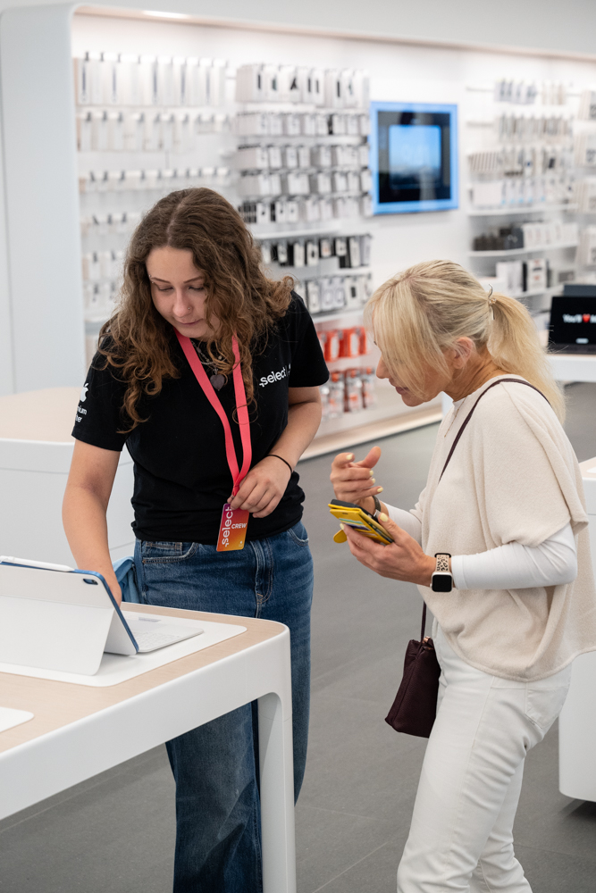 A Select colleague advising a customer in store