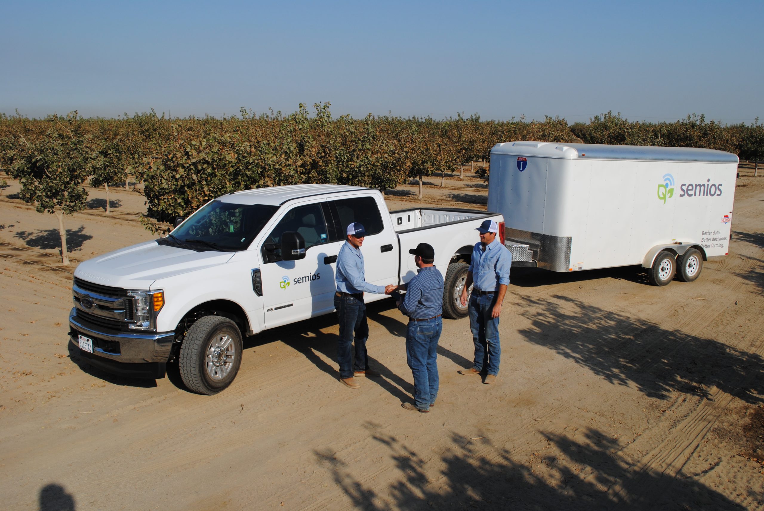 Semios team meeting a grower in an almond