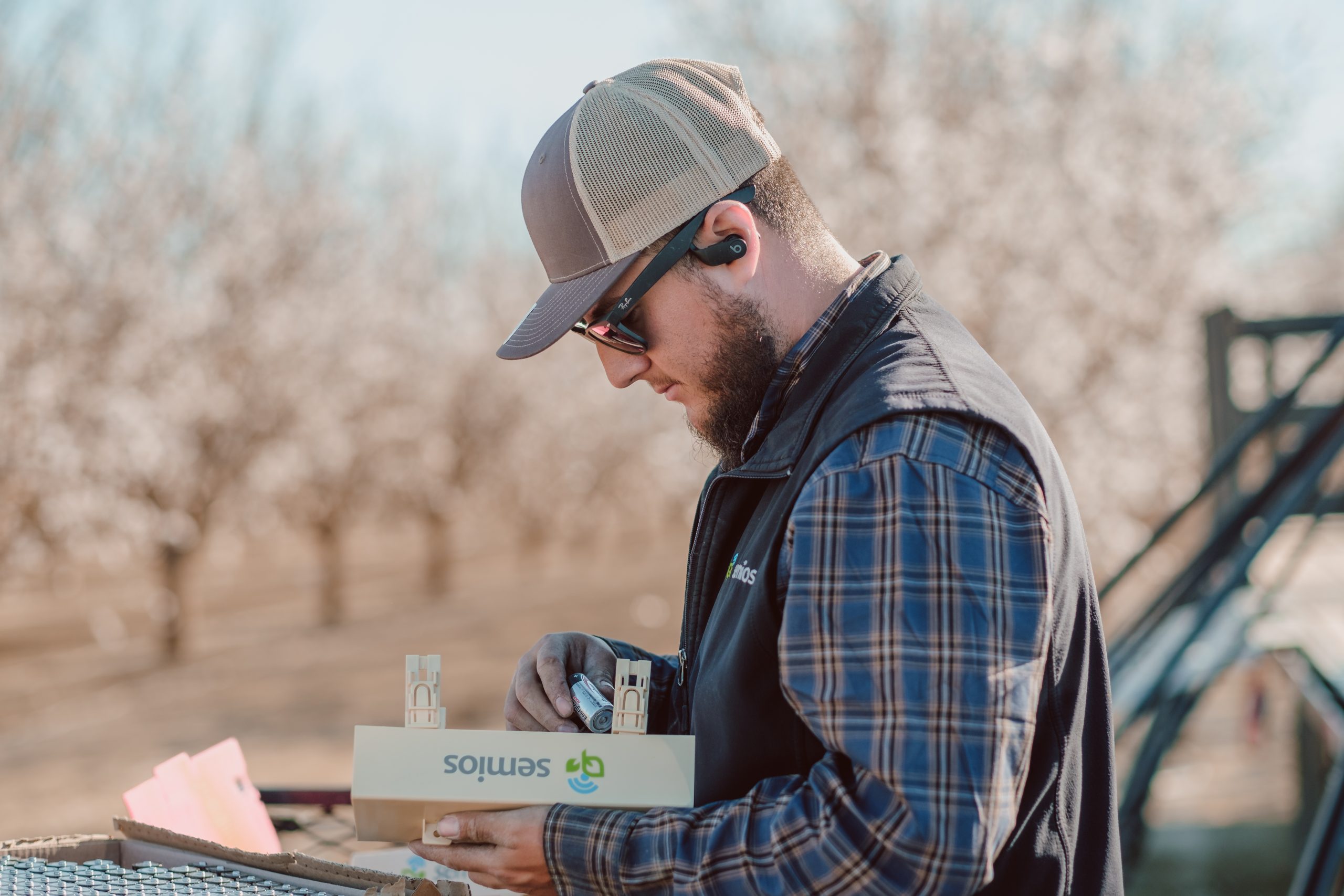 Semios team in the field helping with maintenance.