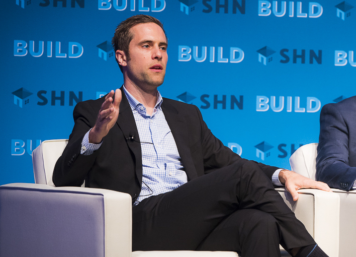 Solera CEO Adam Kaplan seated on stage at BUILD conference