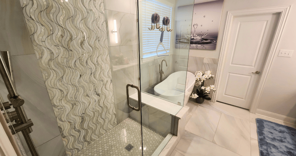 Bathroom with a glass shower enclosure and freestanding bathtub
