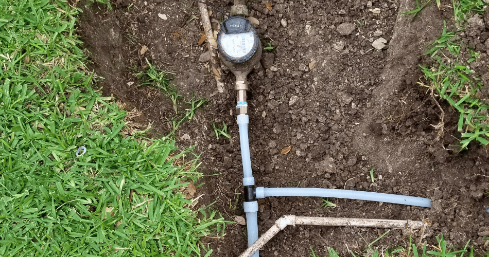 Water meter and pipe connections exposed for water line work