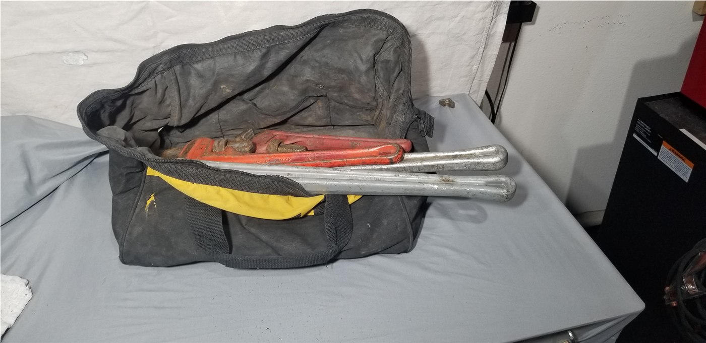 Sergeant Plumber’s working pipe wrenches organized in a tool bag