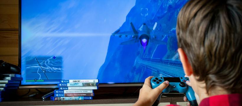 back view of a child playing a video game