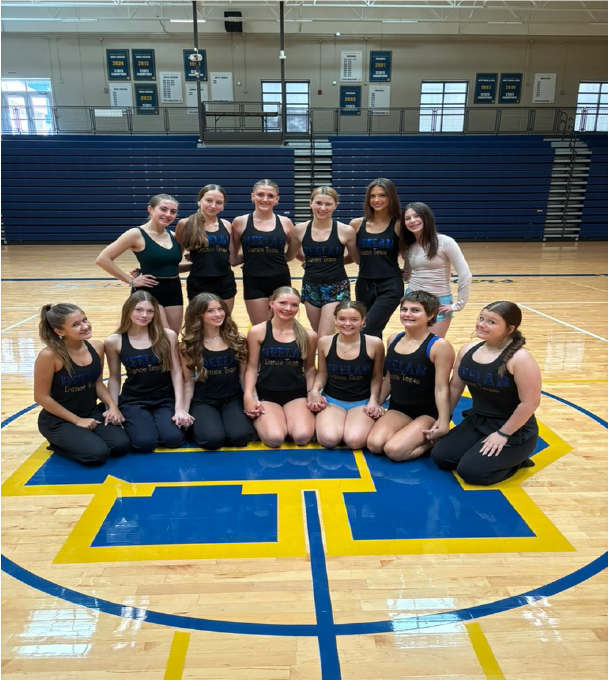 SOLO CUSTOM competetitve dancewear COSTUME CREATED BY SEWN 2 custom-fit dance costumes DANCE BLACK VELVET ONE SLEEVE WITH RUFFLE AND LARGE ROSE ON FRON Briar Cliff University in dance team in their custom game day costumes made by sewn 2 dance2025 performing on football field Our Story Sewn 2 Dance custom designs including Alterations and Embellishments behind the brand custom dancewear step 5 embellishments and rhinestoning, all the hand finishing touchs that make the costume our services team branding for HEELAN HIGH SCHOOL Custom pom and cheer uniform design for school teams CITY IOWA DANCE TEAM IN SCHOOL COSTUME SHIRTS EMBELLISHED BY SEWN 2 DANCE