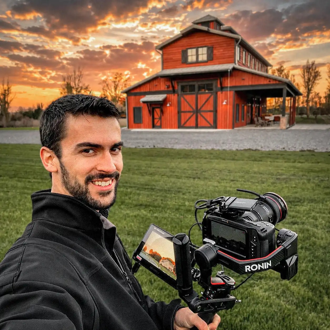 Shad Eash with a Canon camera taking pictures of a Red elegant Barn, epic sky