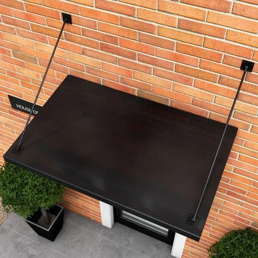 Matte black solid-top aluminium canopy on tie-rods above a door on a brick wall