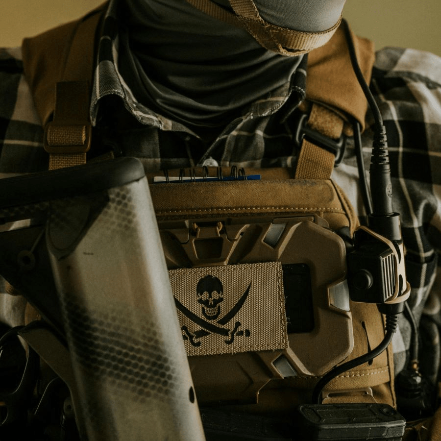 A MOLLE phone mount on a chest rig stock photo. 