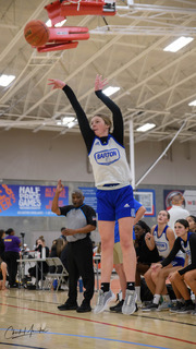 Girl shooting a basketball.