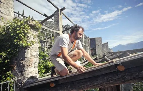 roofer installing shingles on a roof
