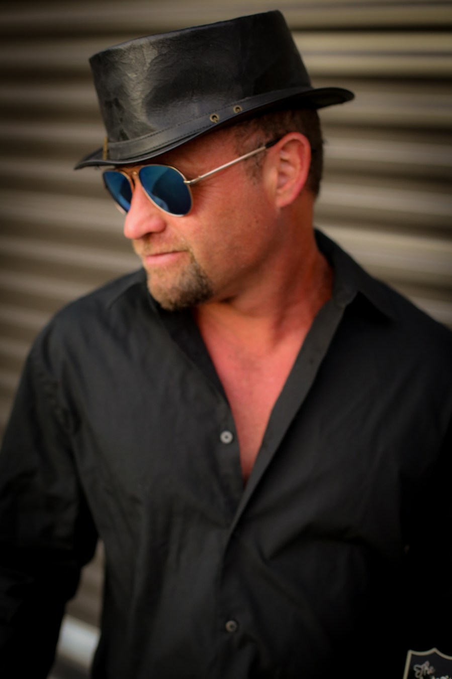 Shane Dwight in a black hat and sunglasses
