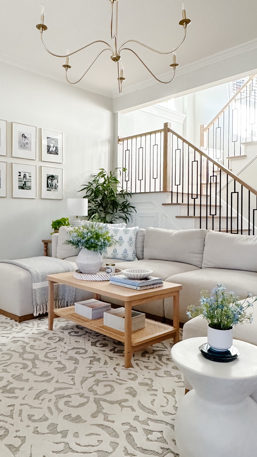 Shannon’s current living room with a light sectional, wood coffee table, and blue-and-white decor