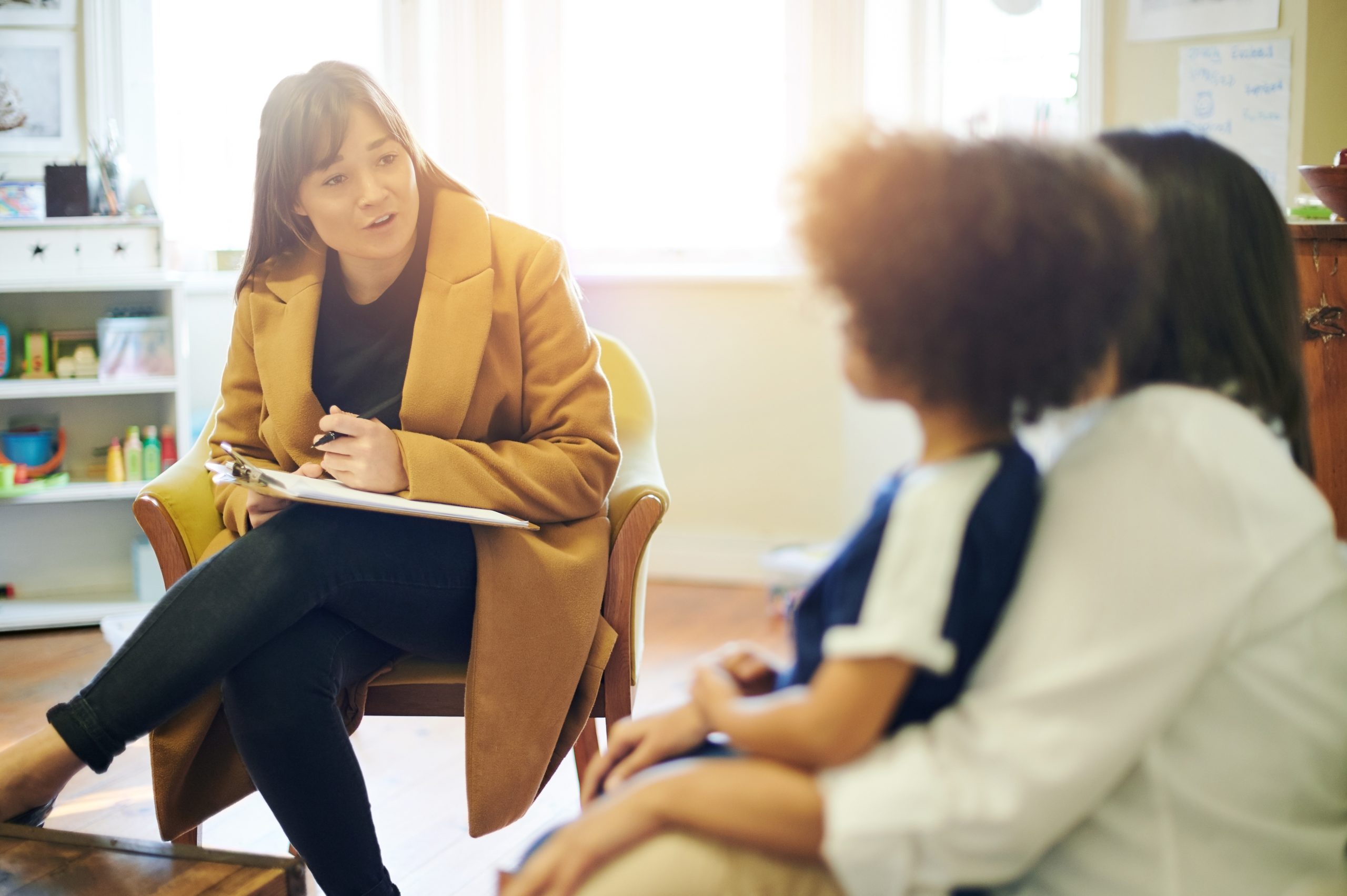Support, talking and a therapist with a child and parent for discussion about education. Help, therapy and therapist speaking to a kid and mom about helping with mental health and learning disability