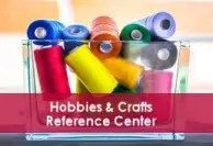 Colorful spools of thread in red, yellow, blue, green, purple, and pink arranged in a clear plastic container. A red banner across the lower portion of the image displays the text “Hobbies & Crafts Reference Center.”