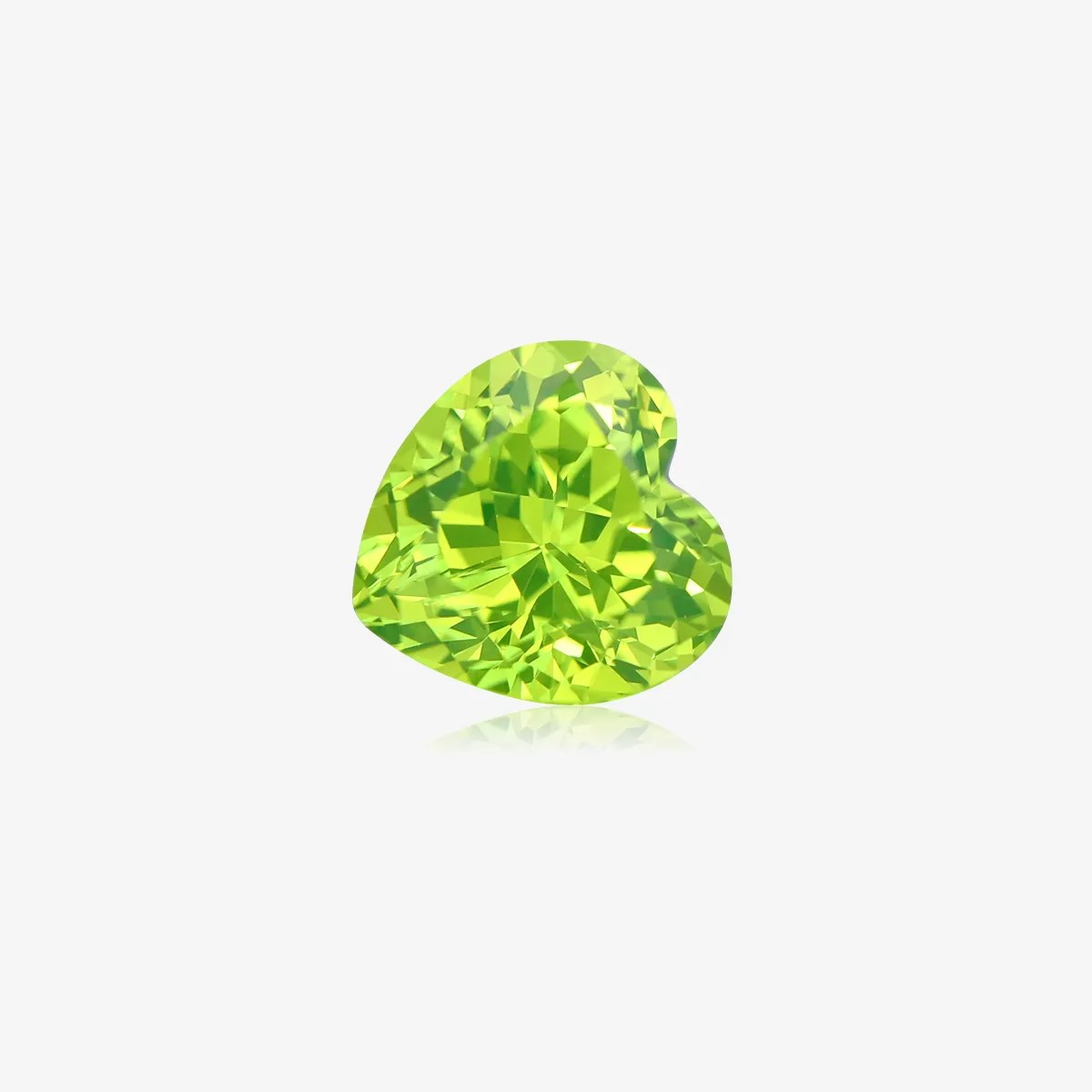 Heart cut LuAG loose gemstone glowing green lab grown crystal