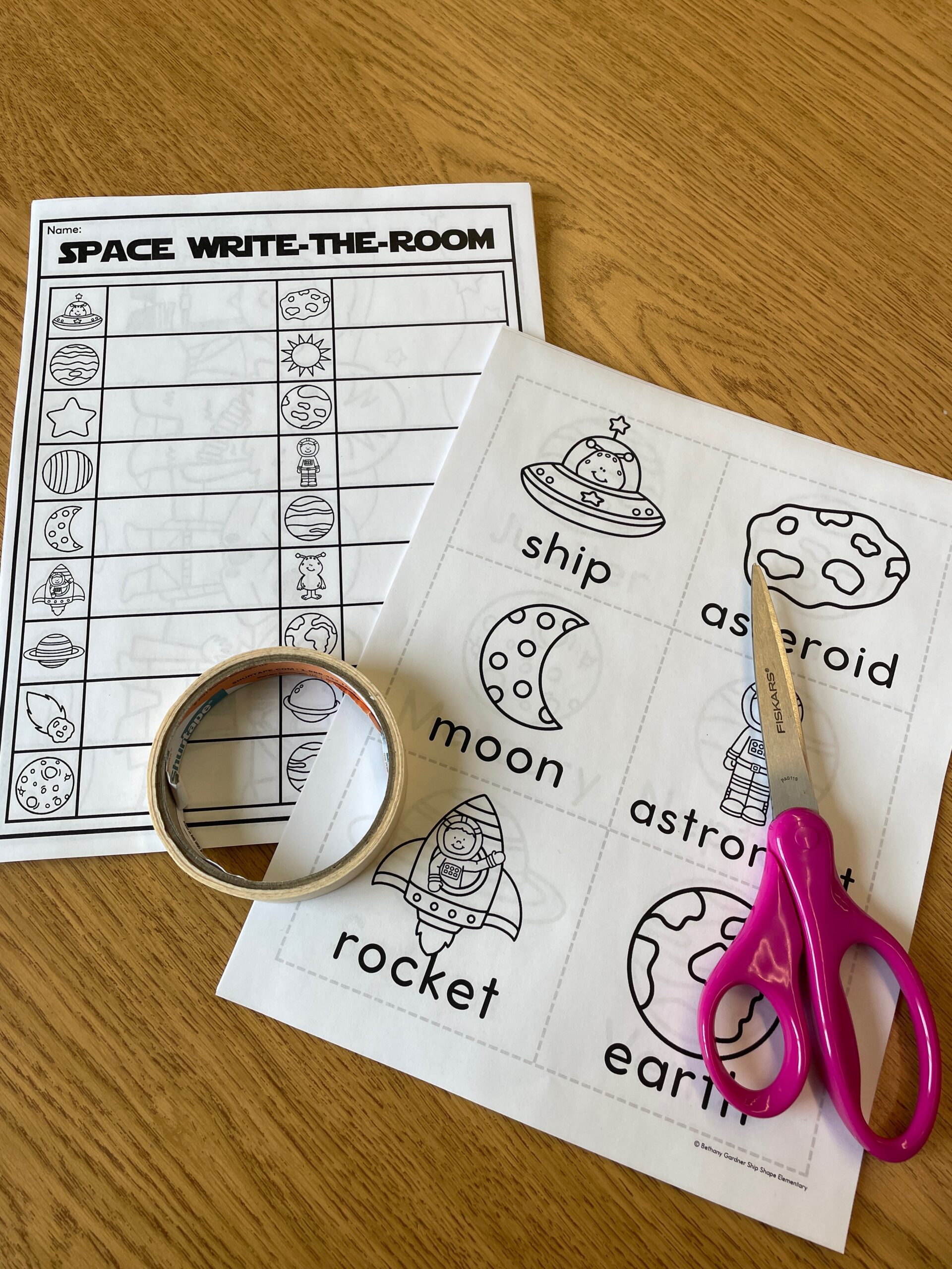 a space-themed write-the-room worksheet activity in a first grade classroom