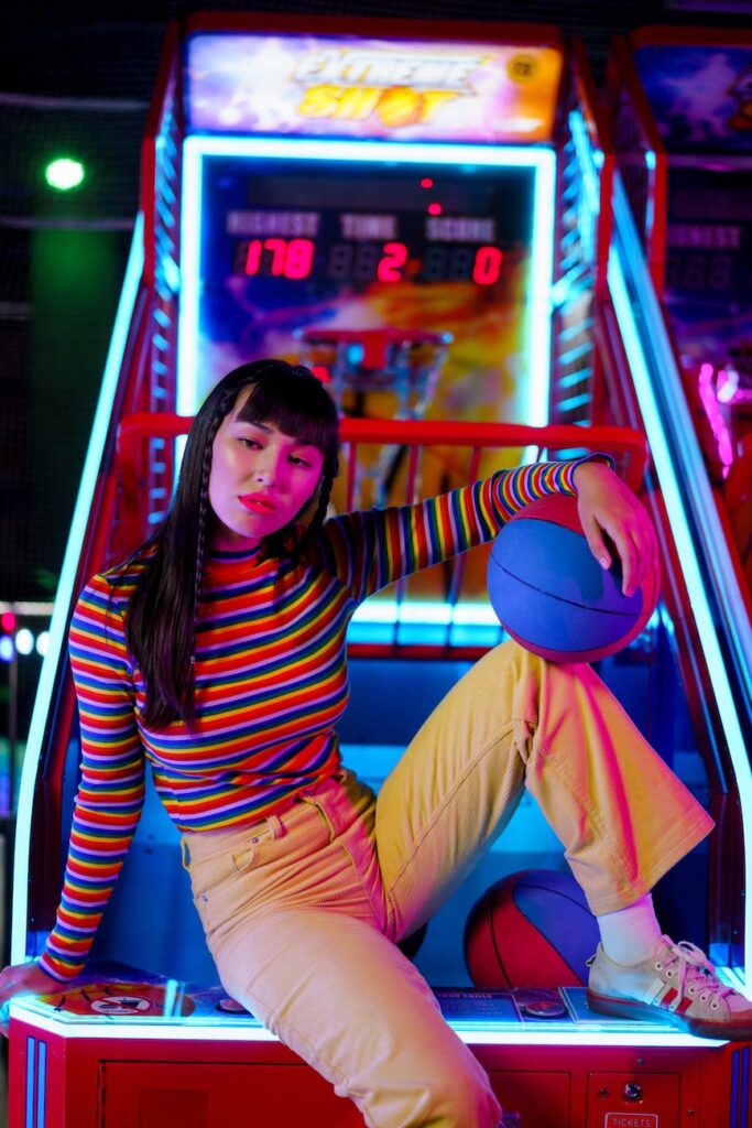 stylish young woman sitting on an arcade