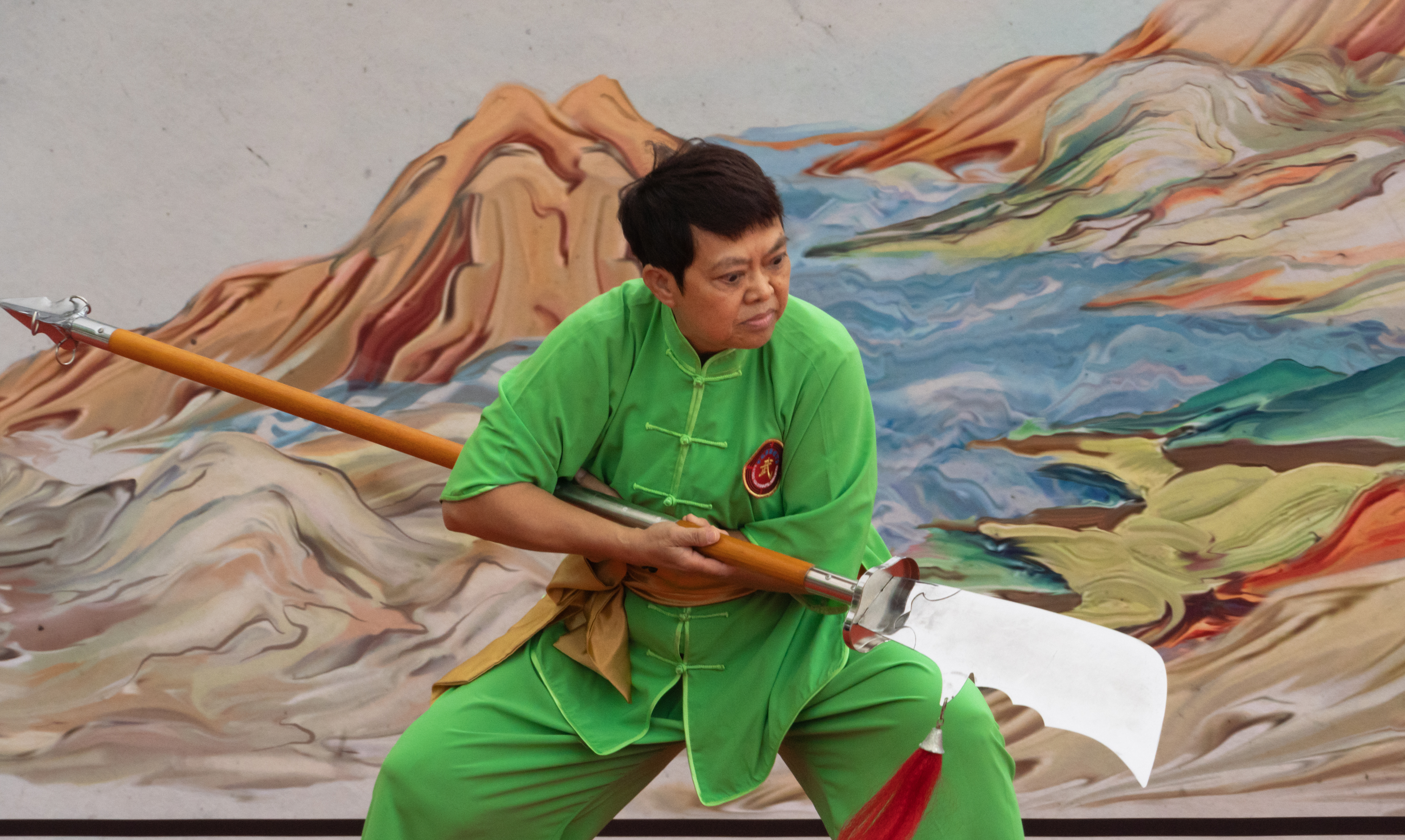 A woman displaying the use of broadsword in Kung Fu
