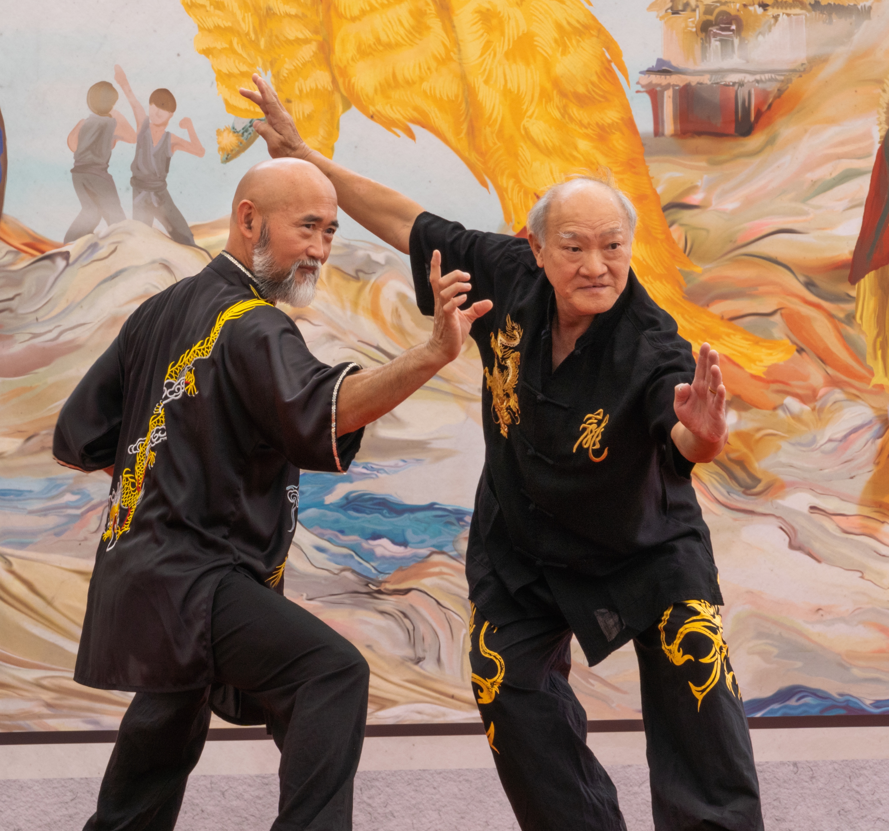 Two Kung Fu performers getting photos together in Kung Fu poses