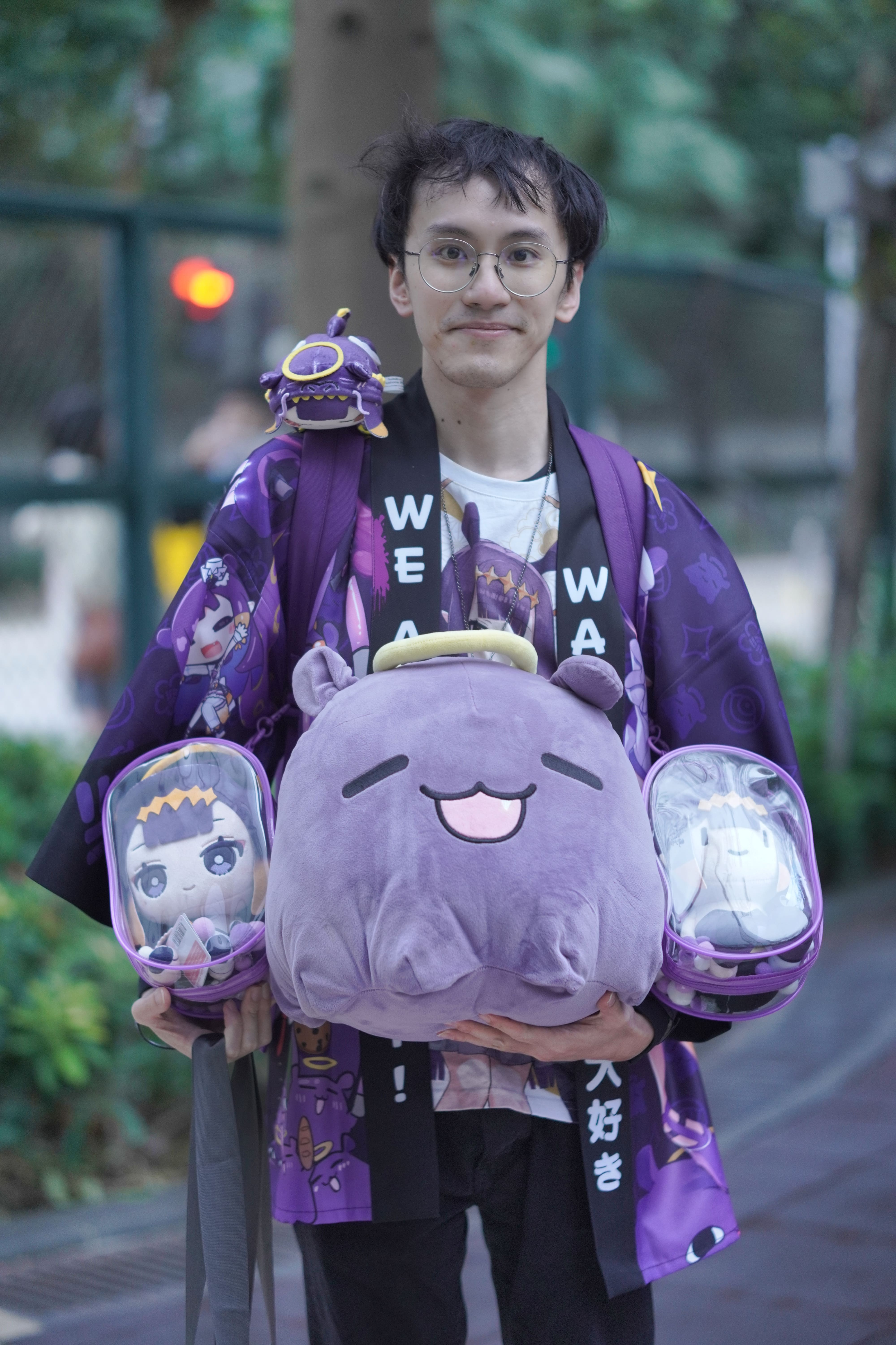 Connor Poon posing with all his Ina merch, Sunday, March 30, 2025