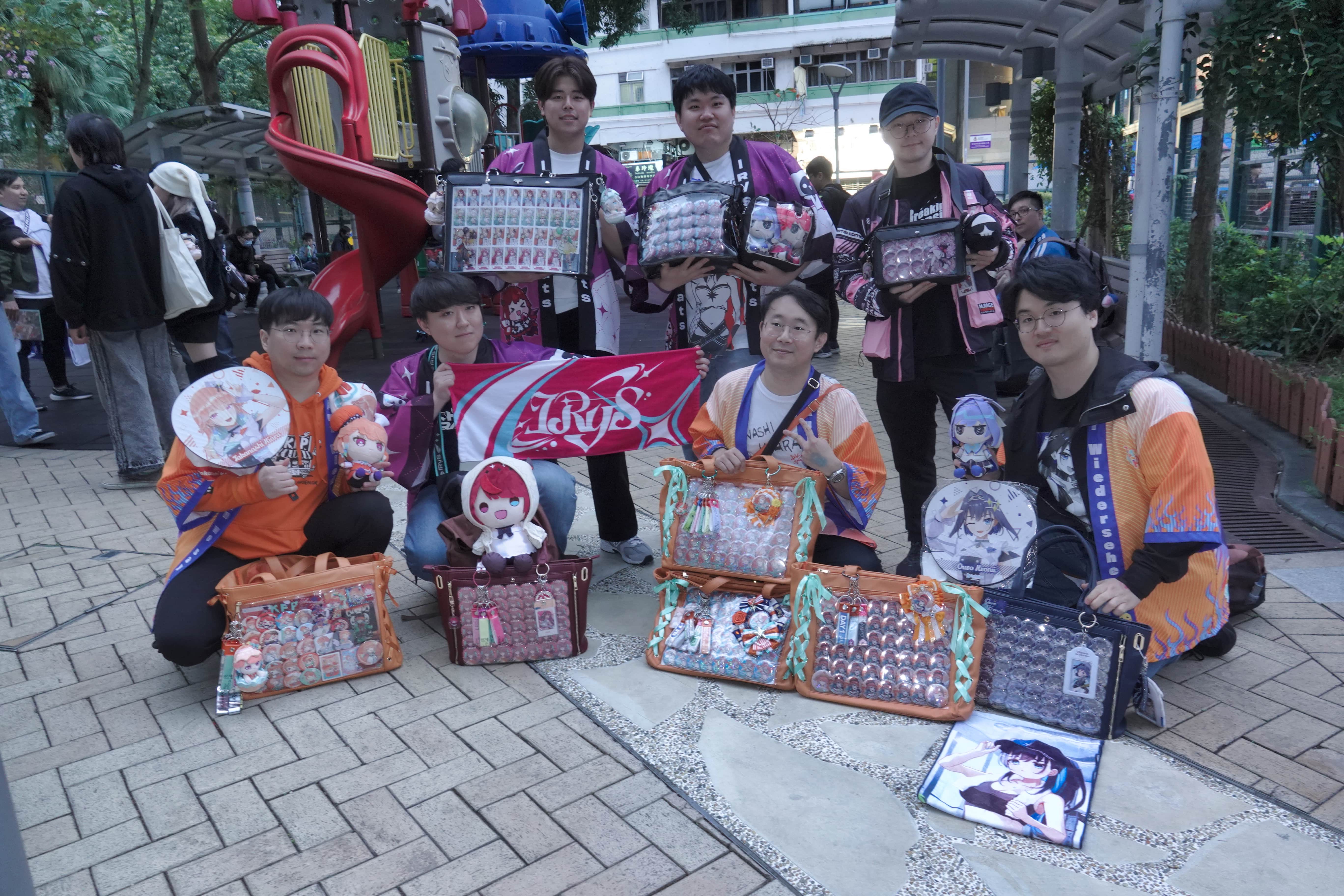 Minkeon Kim (top centre) and William Choi (bottom center-right) posing with Hololive merchandise alongside other Korean Hololive enthusiasts whilst wearing the talents&rsquo; official birthday hanten jacket, Sunday, March 30, 2025. The group continued their banter with each other in Japanese. (Photo taken by Yohji Lam)
