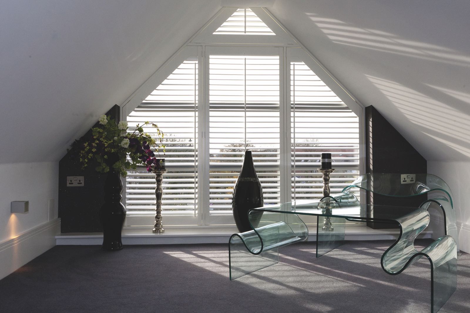 Bespoke plantation shutters fitted to a triangular shaped window