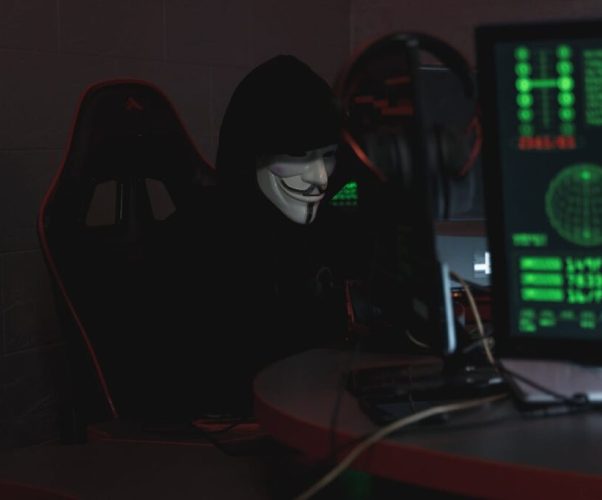 pexels-photo-5380605 Person Wearing a Mask Sitting on CHair while Using a Computer