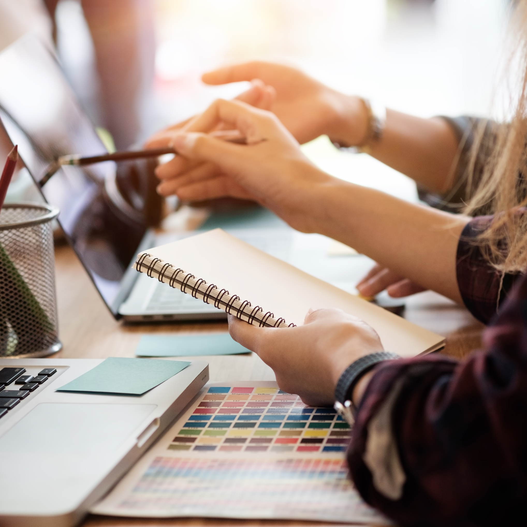 Two women talking and pointing at a computer