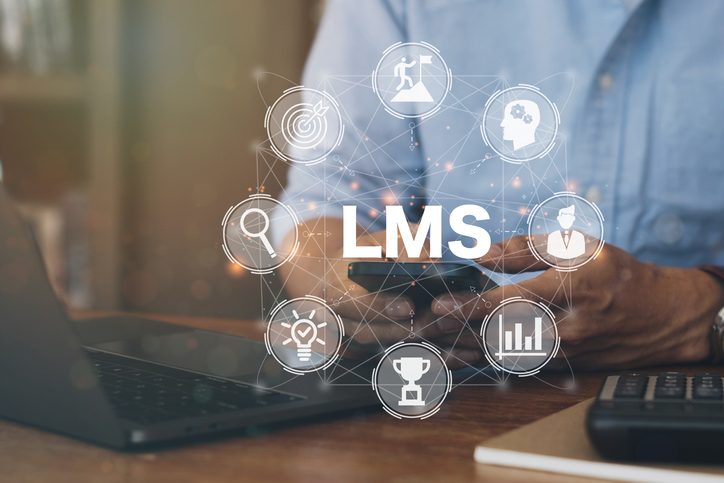 The image shows a person using a smartphone and laptop, with a digital overlay featuring the term "LMS" (Learning Management System) surrounded by interconnected icons representing learning, achievements, analytics, and education. The design emphasizes online learning and digital training platforms.