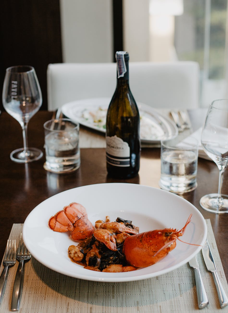 delicious appetizer with boiled lobster and wine
