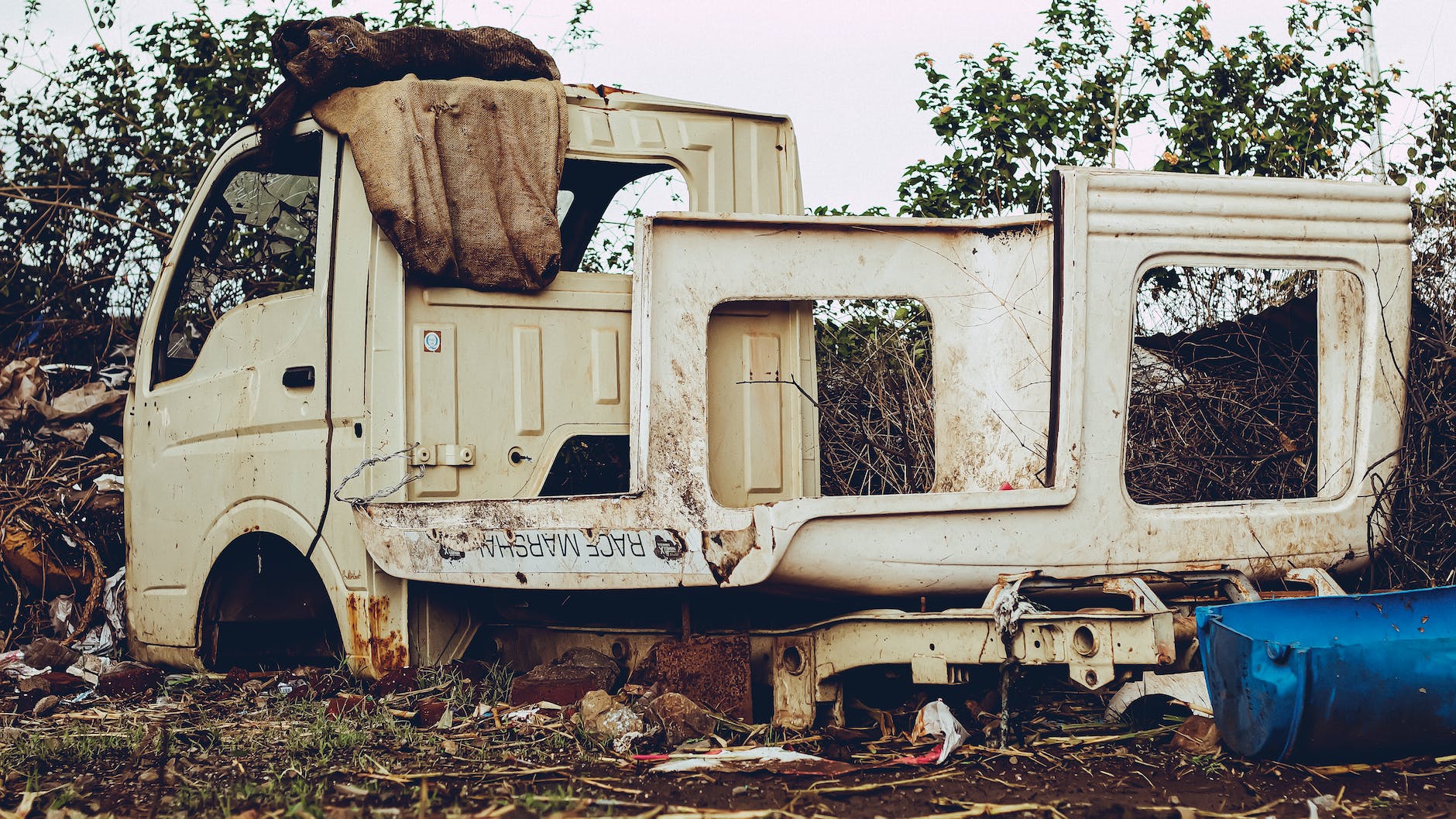 broken abandoned car on derelict site