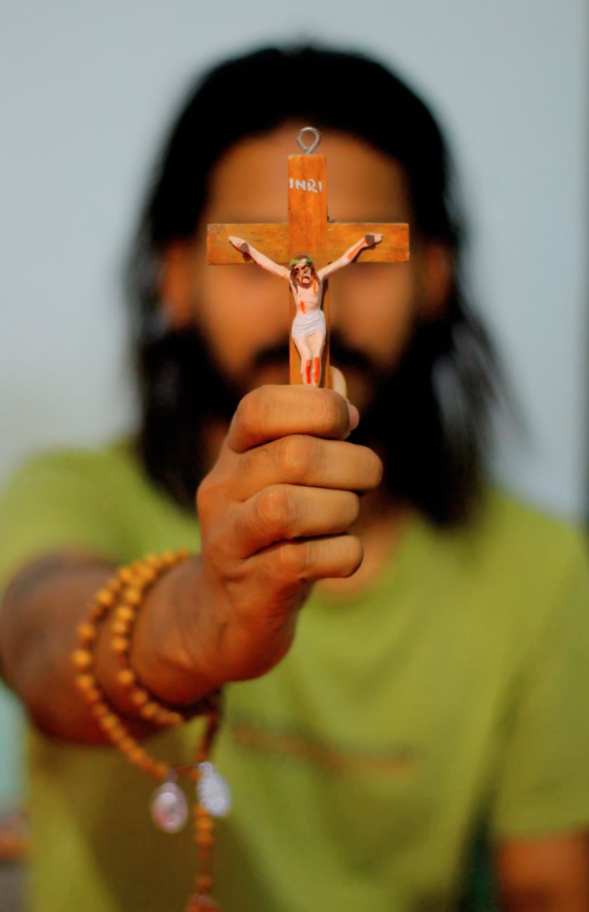 man holding crucifix