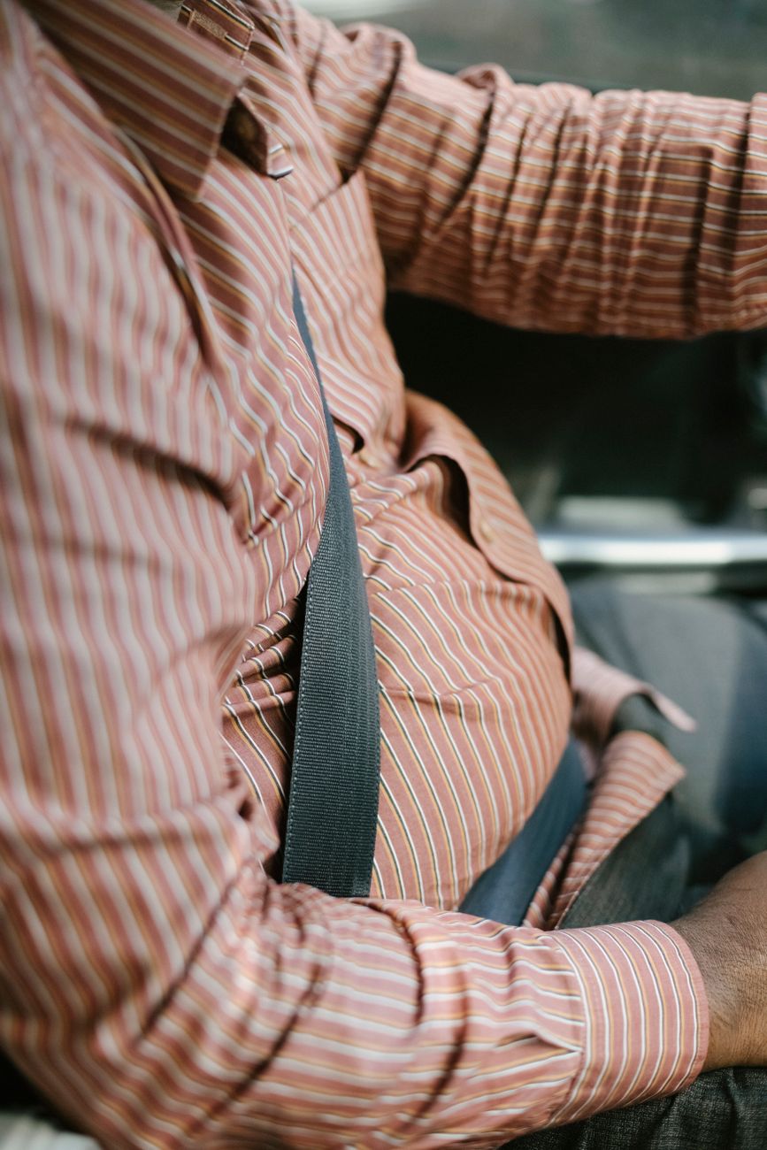 faceless ethnic driver in ornamental shirt in transport