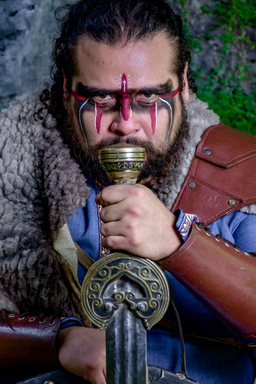 warrior with tribal face paint and sword