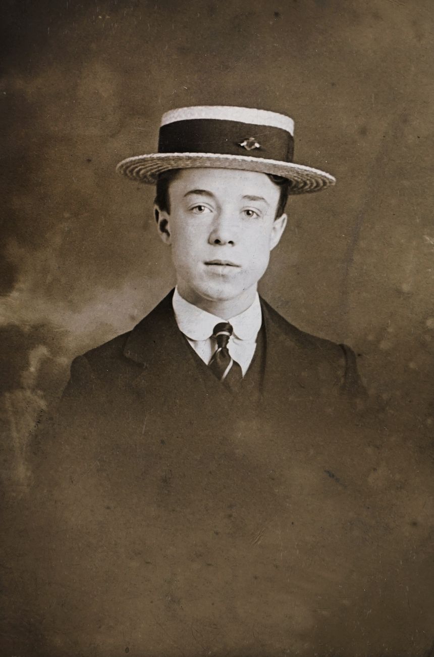 classic photo of man in formal wear with hat