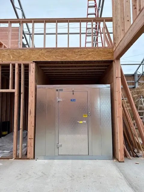 Mechanical room being installed inside a custom equestrian barn during construction.