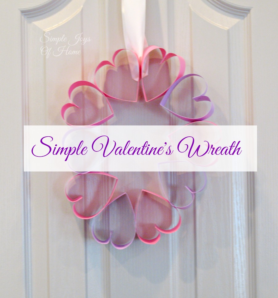 Paper heart wreath on door with text overlay which reads Simple Valentine's Wreath