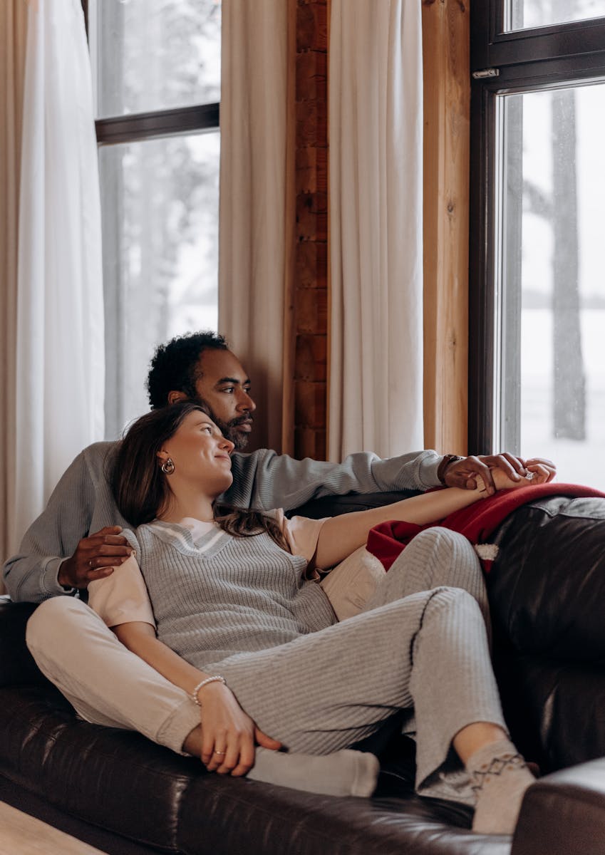 A couple enjoying a cozy moment together indoors during winter.
