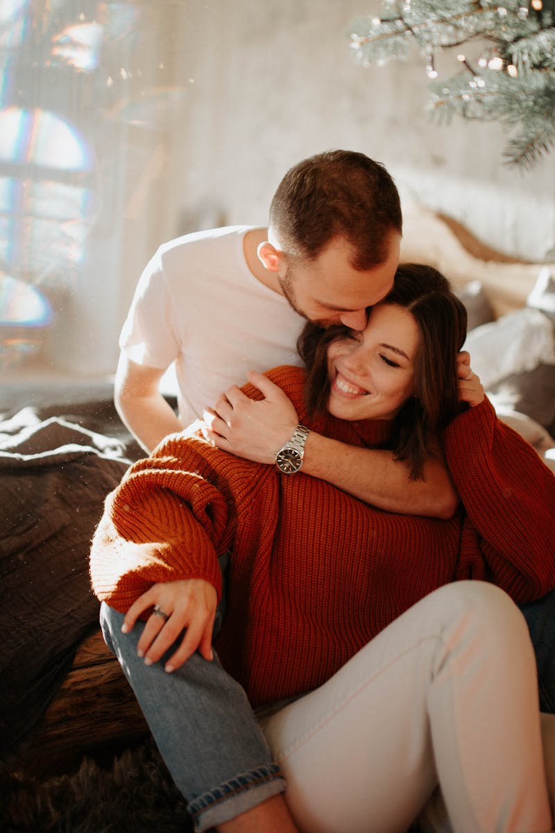 A loving couple embracing in a cozy home setting, showcasing warmth and togetherness.
