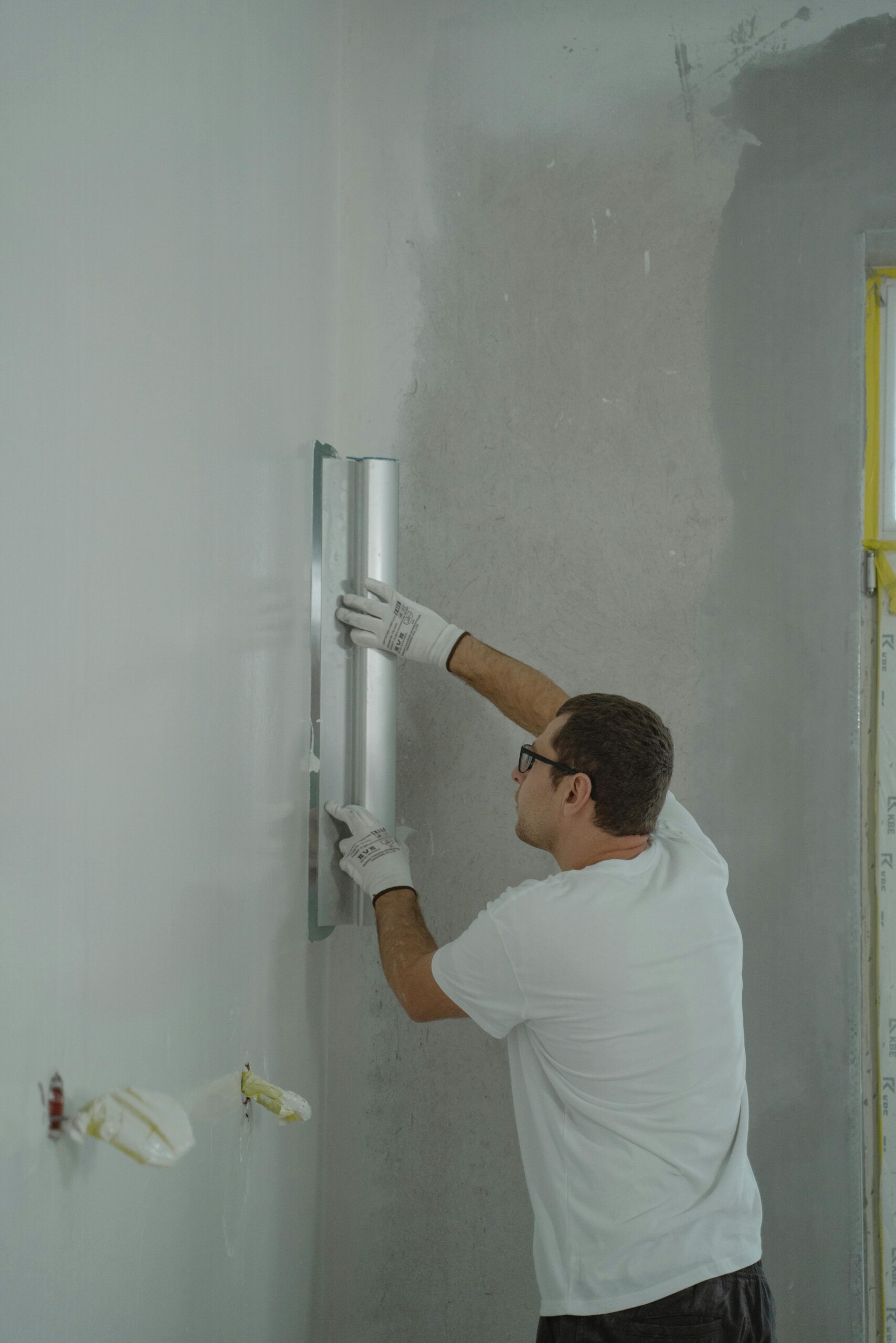Worker applying plaster for waterproofing services Barnslis