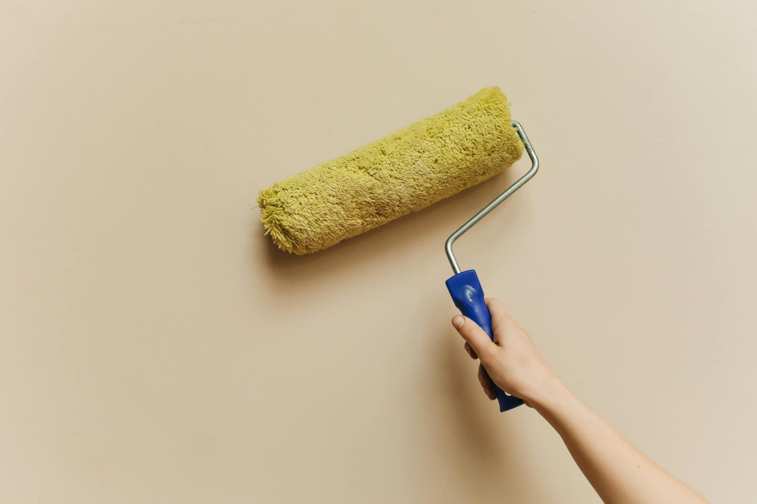 Ceresit CT 74 colour options applied with paint roller on rendered wall