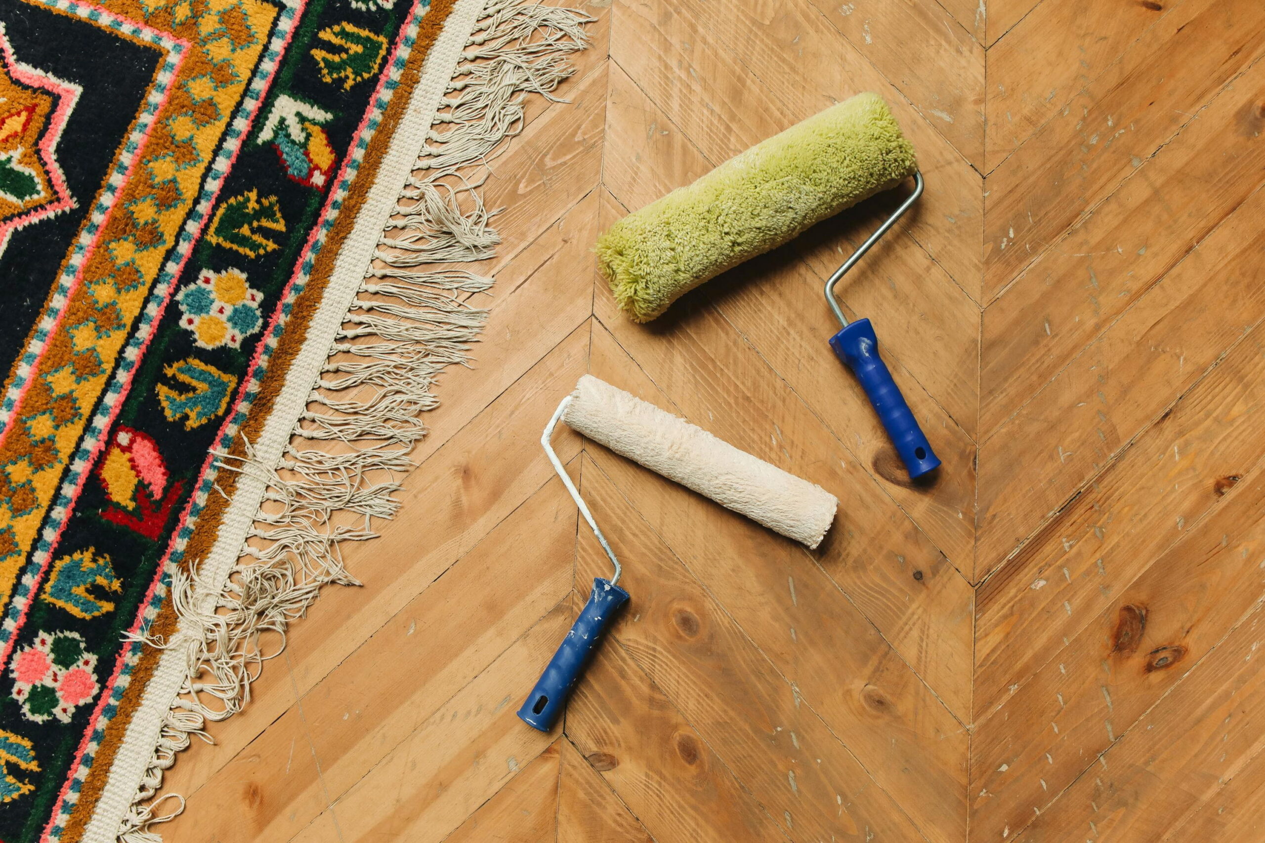 Mixing small batches of render with painting rollers on wooden parquet floor