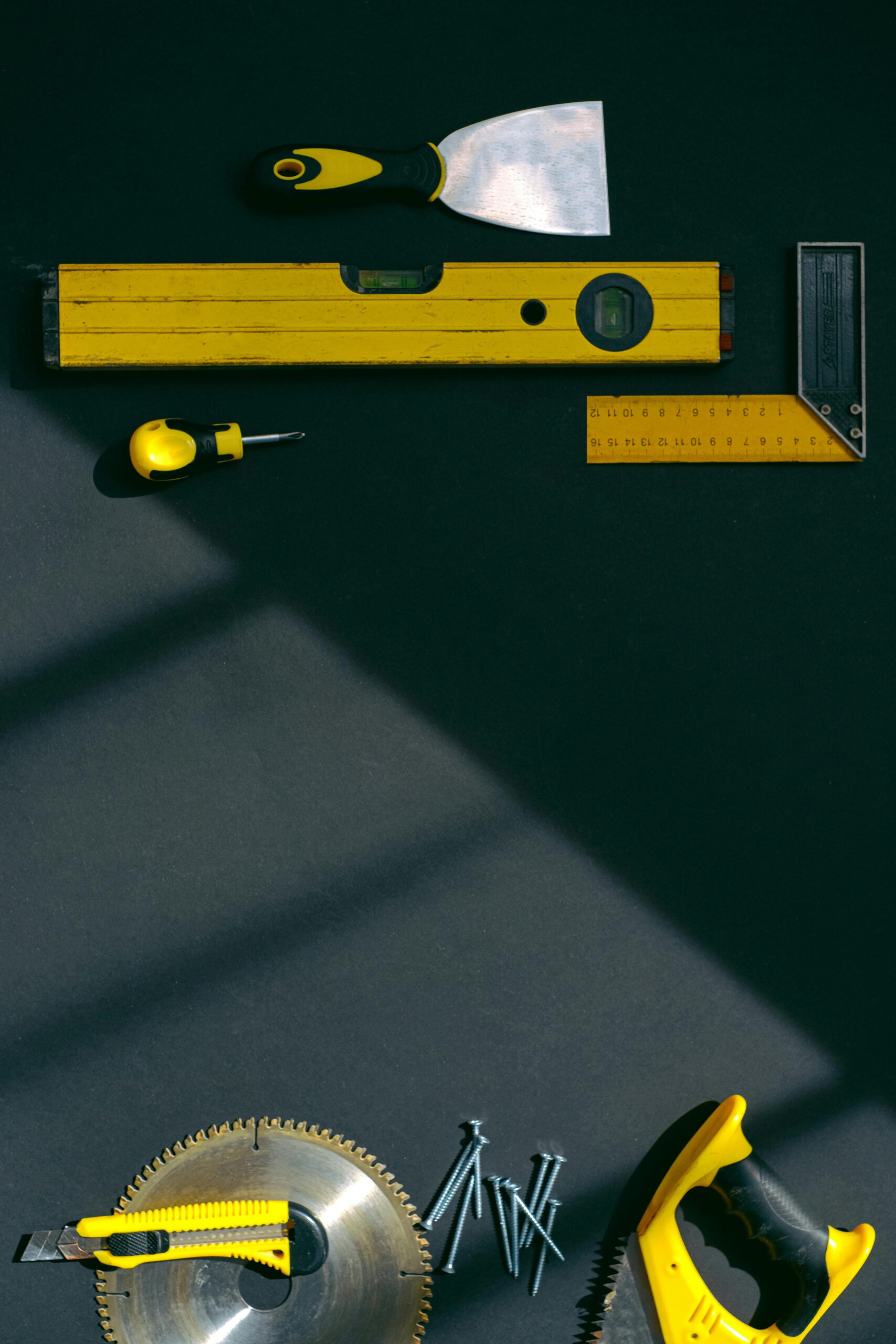 render patch repair tutorial tools including a plastering trowel, spirit level, measuring square, screws and saw blade