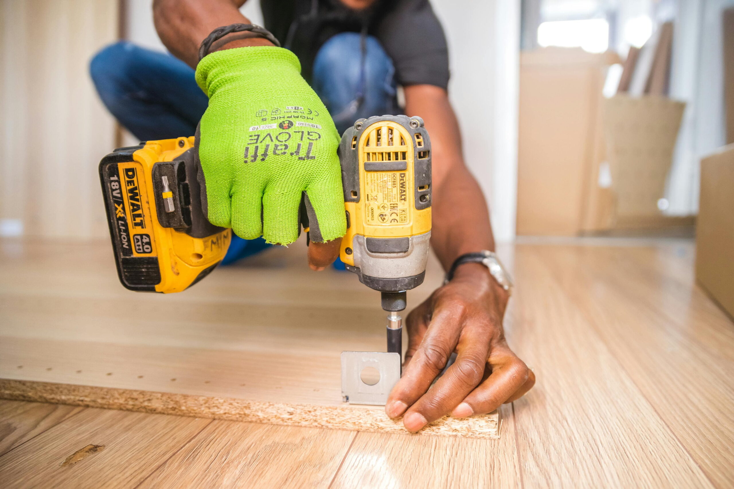 Worker drilling external render bracket for condensation prevention in solid-wall homes