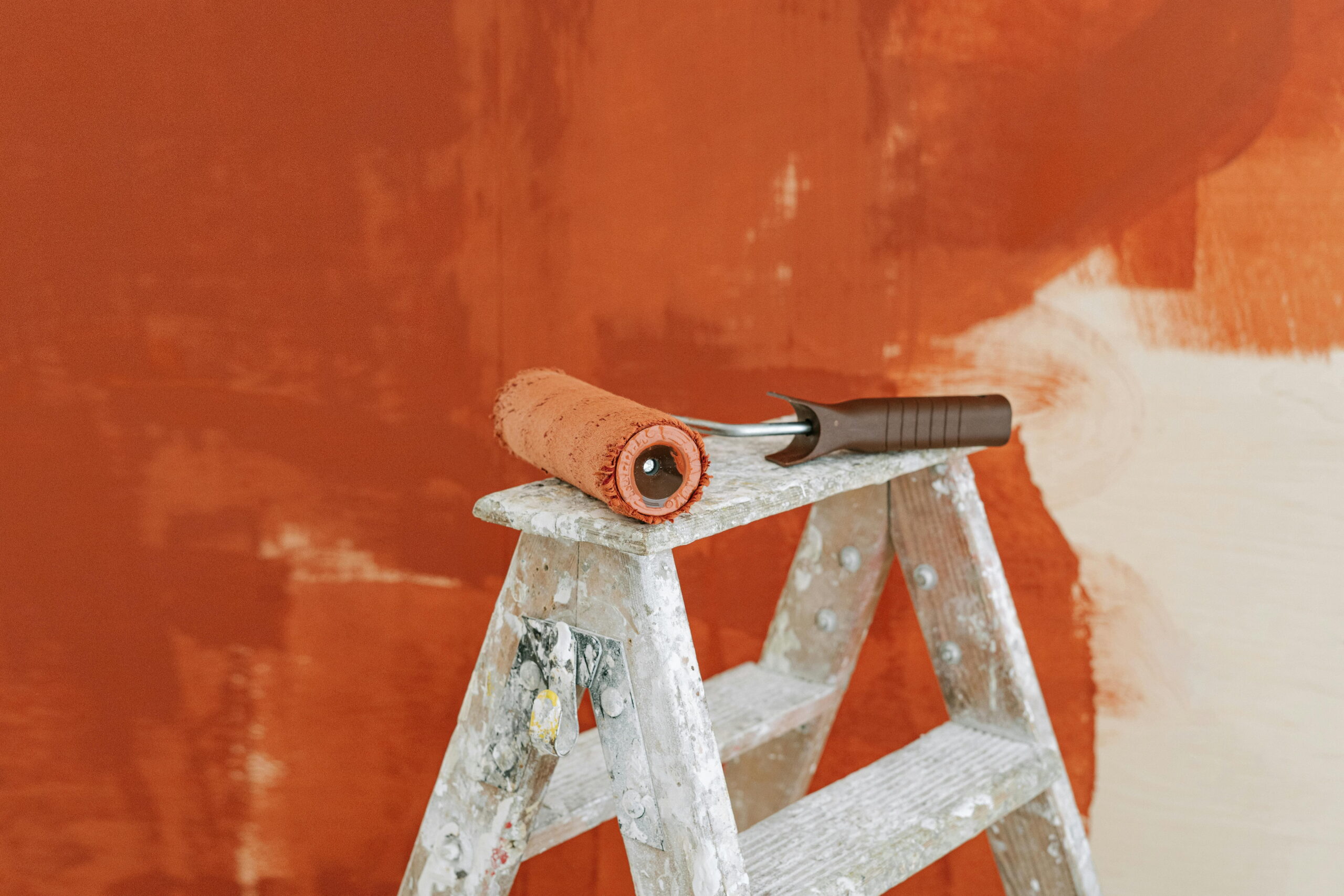 Retrofitting 1930s semis with EWI using a paint roller on ladder